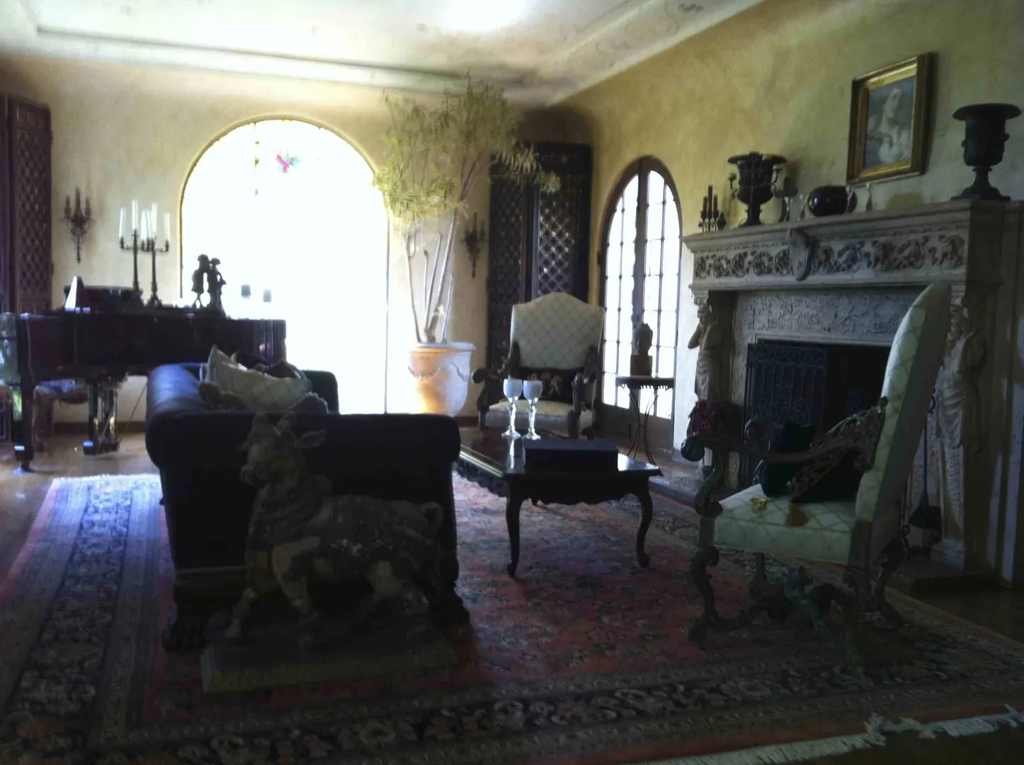 Cozy vintage living room with antique furniture and warm lighting.