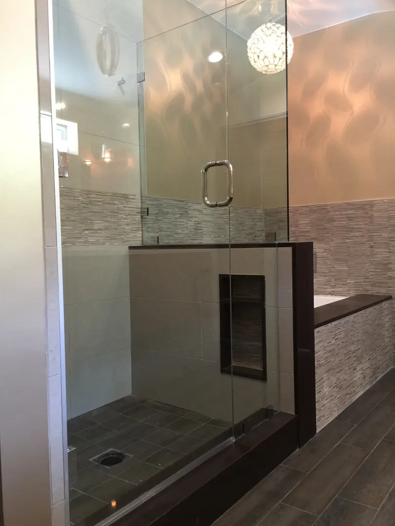 Modern bathroom with glass shower and built-in niche.