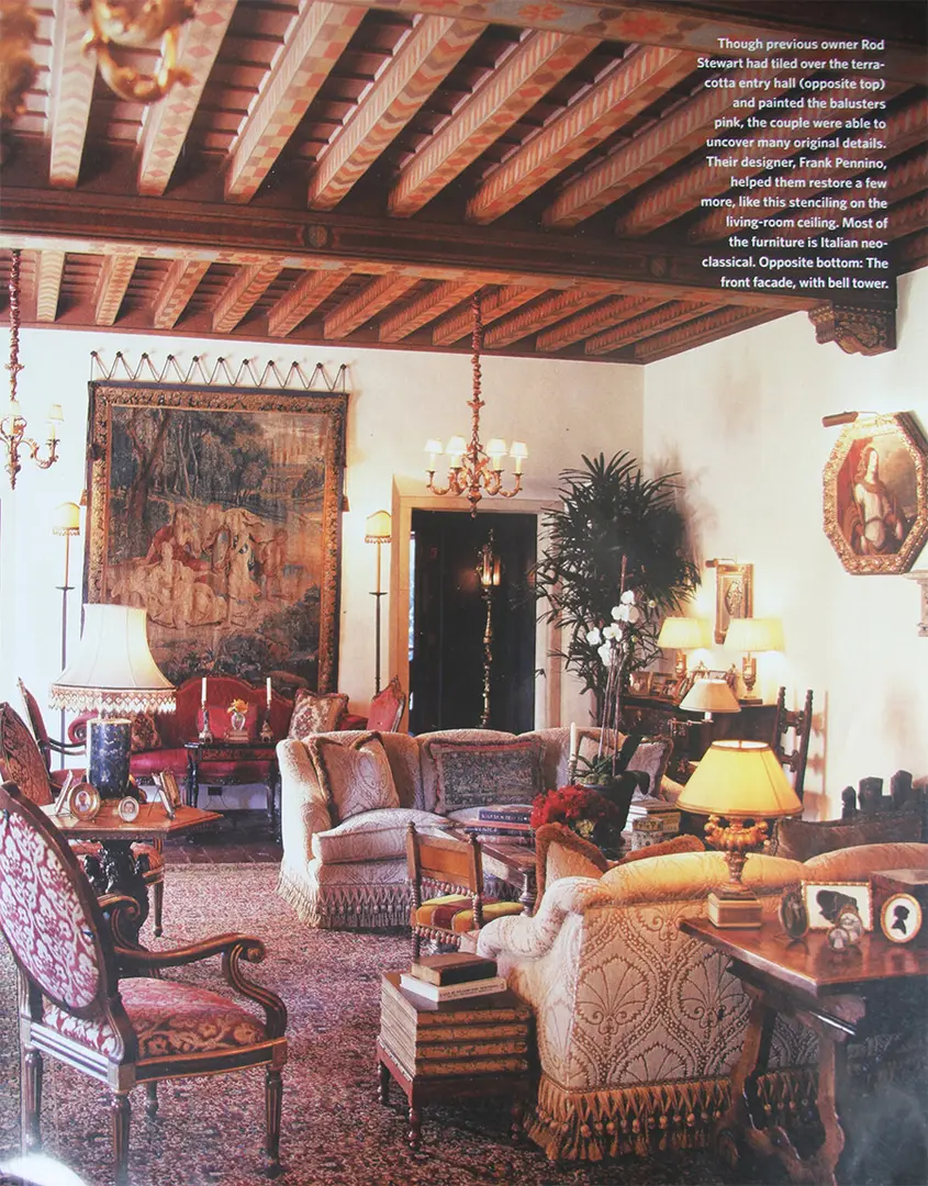 Elegant living room with classic furniture and wooden ceiling beams.