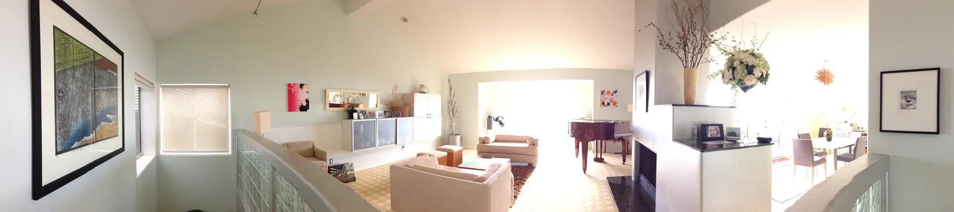 Bright living room with modern furniture and large windows.