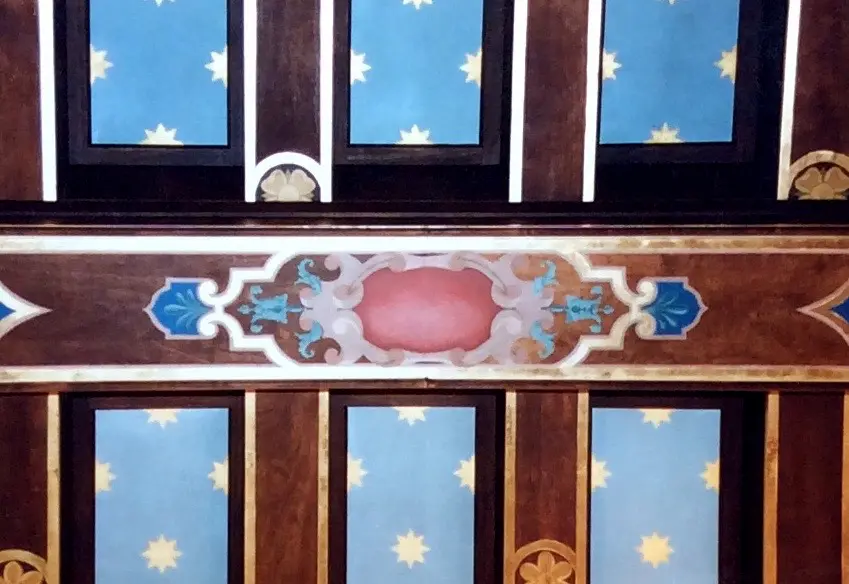 Intricate ceiling panel with floral and geometric designs.