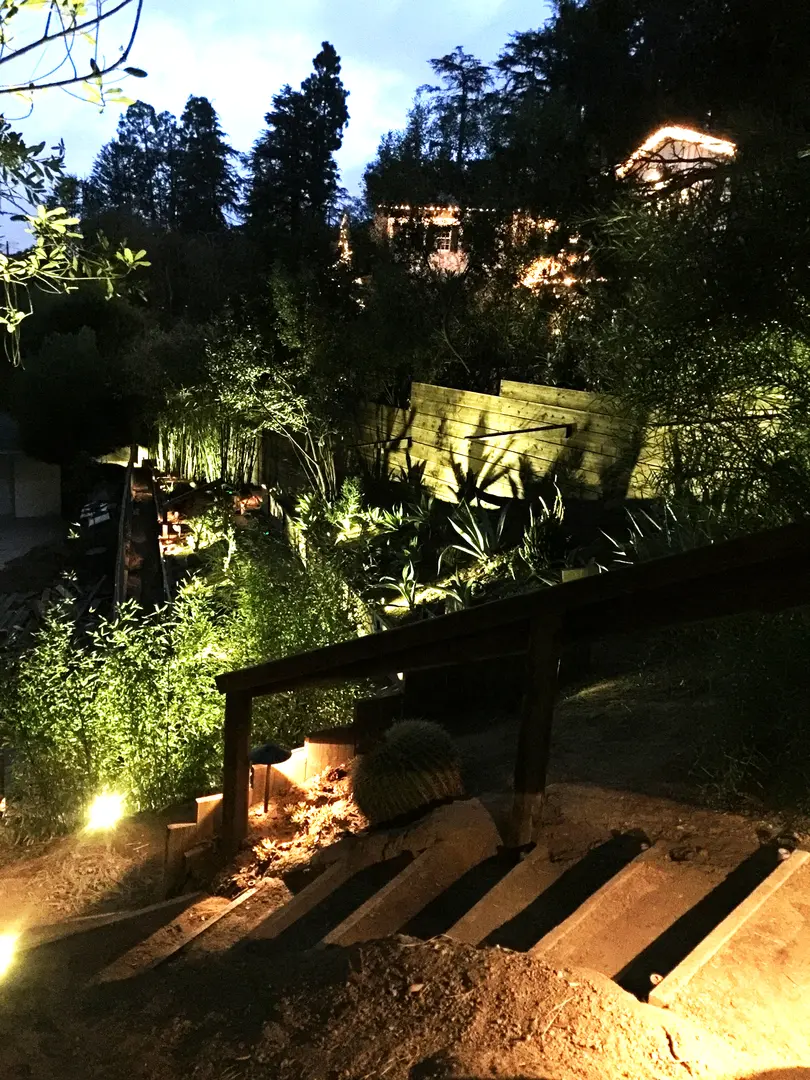 Cozy outdoor seating area illuminated by soft garden lights at night.
