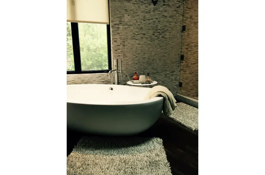 Hotel washroom interior with washing basin and towel